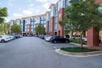 The-Flats-at-Carrs-Hill-Apartments-Near-UGA-Community-Building-Exterior-Resident-Parking